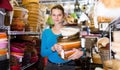 Portrait of girl with pile of different wicker basket