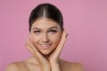 Portrait of pretty girl on pink background, space for text. Beautiful face with perfect smooth skin Royalty Free Stock Photo