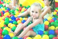 Portrait of girl playing in pool with plastic multicolored ball