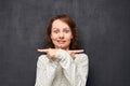 Portrait of girl pointing with forefingers in opposite sides