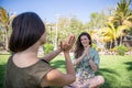 Portrait of a girl practicing yoga with her friend in a tropical meadow Royalty Free Stock Photo