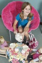 Midsection of girl pretending to have tea party with her dolls