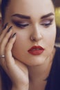 Portrait of a girl with professional make-up,.smoky eyes, red lips and smooth eyebrows. Limbed eyebrows.