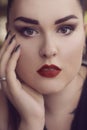 Portrait of a girl with professional make-up,.smoky eyes, red lips and smooth eyebrows. Limbed eyebrows.
