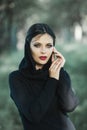 Portrait of girl pulling her trendy sweater over head having fun. Outdoor atmospheric lifestyle photo of young beautiful lady Royalty Free Stock Photo