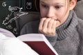 Portrait of a girl reading very interesting, scary book