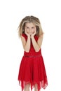 Portrait of girl in red frock with head in hands over white background