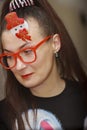 Portrait of a girl in red glasses with snowmen