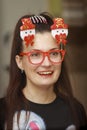 Portrait of a girl in red glasses with snowmen