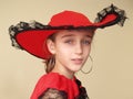 Portrait of a girl in red hat and dress with black lace