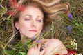 Portrait of a girl with a roof plan. Beautiful girl among the grass and color. Portrait of a girl on the shoulders