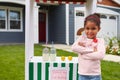 Portrait Of Girl Running Homemade Lemonade Stand