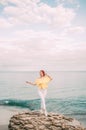 Portrait girl on sea beach in stylish wear, stylish wear, skin care, brunette hipster enjoy the sea, happy dreamer, girl in white