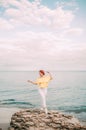 Portrait girl on sea beach in stylish wear, stylish wear, skin care, brunette hipster enjoy the sea, happy dreamer, girl in white