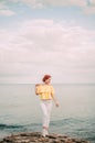 Portrait girl on sea beach in stylish wear, stylish wear, skin care, brunette hipster enjoy the sea, happy dreamer, girl in white