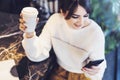 Portrait of girl sitting cafe, using smartphone. Young woman reads text message on phone while sitting coffee shop. Lifestyle Royalty Free Stock Photo