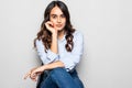 Portrait of a girl sitting on a chair over gray background Royalty Free Stock Photo