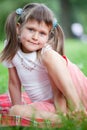 Portrait of girl sitting on plaid, grass in park Royalty Free Stock Photo