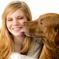 Portrait of girl snuggling with her dog