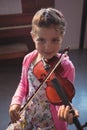 Portrait of girl student rehearsing violin