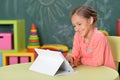 Portrait of girl studing with tablet at classroom Royalty Free Stock Photo