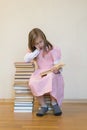 Portrait of a girl teenager reading book. education and school concept. The child is reading. A little cute girl in a pink dress Royalty Free Stock Photo