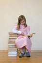 Portrait of a girl teenager reading book. education and school concept. The child is reading. A little cute girl in a pink dress Royalty Free Stock Photo