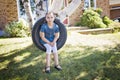 Portrait of girl on tire swing Royalty Free Stock Photo