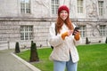 Portrait of girl tourist, wonders around city with smartphone map application, holding mobile phone and smiling, looking Royalty Free Stock Photo