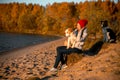 Portrait of girl with two funny border collie dog on beach at seaside. autumn yellow forest on background Royalty Free Stock Photo