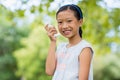 Portrait of girl using an asthma inhaler in the park Royalty Free Stock Photo