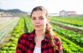 Portrait of girl vegetable grower in family vegetable farm
