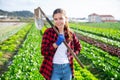 Portrait of girl vegetable grower in family vegetable farm