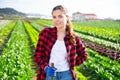 Portrait of girl vegetable grower in family vegetable farm