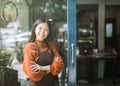 Portrait of girl waitress wearing apron and standing in front