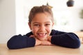 Portrait Of  Girl Wearing School Uniform Leaning On Kitchen Counter Royalty Free Stock Photo