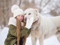 Portrait of a girl and a white large pedigreed dog in winter. Dog alabai Royalty Free Stock Photo