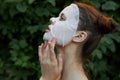 Portrait of a girl white mask outdoors side view naked shoulder bare shoulders