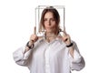 Portrait of a girl in a white shirt with a metal cube-cage on his head. isolate. The concept of estrangement, the man in a case Royalty Free Stock Photo