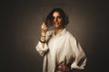 Portrait of a girl in a white shirt with a metal cube-cage on his head. isolate. The concept of estrangement, the man in a case Royalty Free Stock Photo