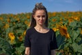 portrait of a girl who stands in the middle of a field of sunflowers Royalty Free Stock Photo