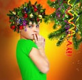 Portrait of a girl in a wreath of fir branches on abstract background Royalty Free Stock Photo