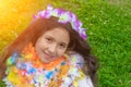 Portrait of a girl of 9 years old sits  and smiles on a sunny day. Spring Girl. Hawaiian garlands Royalty Free Stock Photo