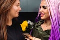 Portrait of girlfriends in the kitchen with smartphone. They look sweetly to each other eyes and smile