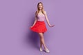 Portrait of girlish stunning pretty cute lady posing wear pink top red mini skirt shoes on violet background