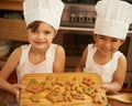 Portrait, girls and Christmas cookies in kitchen, smile and happy for festive, holiday and joy. Xmas, female friends and