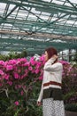 Portrait of girls in the greenhouse full of flowers Royalty Free Stock Photo