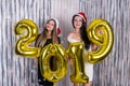 Portrait of girls holding golden air balloons 2019