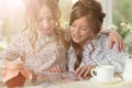 Portrait of girls reading magazine, and drinking tea Royalty Free Stock Photo