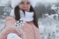 Portrait of girls for a walk in the winter park. The plants are covered with frost and snow. The girl is out of focus